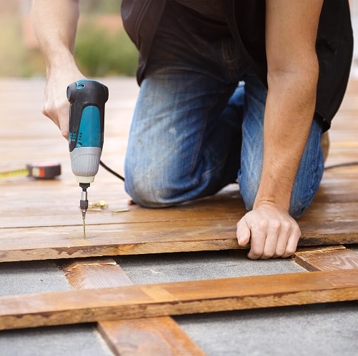 Handyman installing wooden flooring