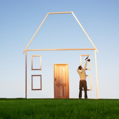 Man using drill on house outline