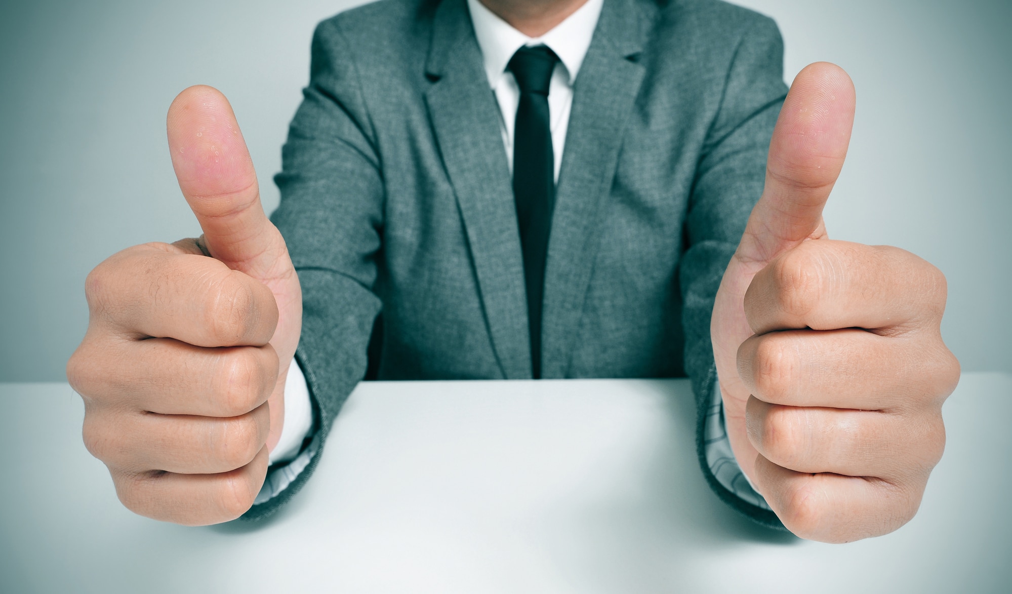 Man In Suit Giving A Thumbs Up Signal